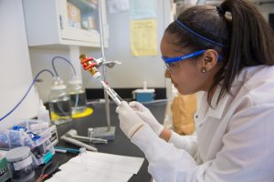 An undergraduate student works in one of Syracuse University's labs.